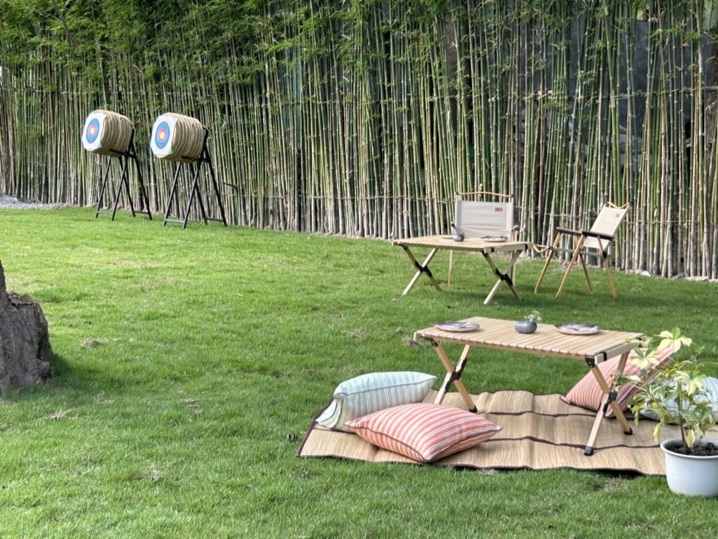 Archery on the lawn beside the bamboo grove